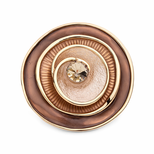“Magneetbroche Bruine Luxe Cirkel met verfijnde gelaagde ringen in bruin- en goudtinten en een fonkelende steen in het midden.”