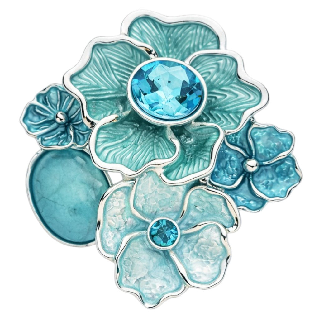 Magneetbroche Nr.49 Bloemenpracht in Blauwtinten met bloemvormen in turquoise en blauw, elegante damesbroche met zilverkleurige details.